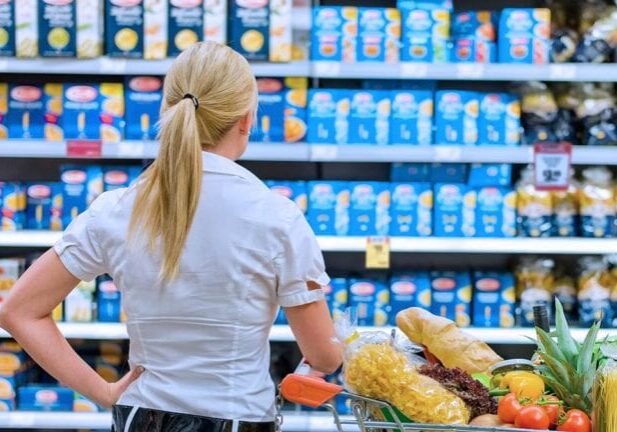 woman looking at unit pricing signs
